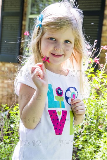 Caucasian girl playing in backyard