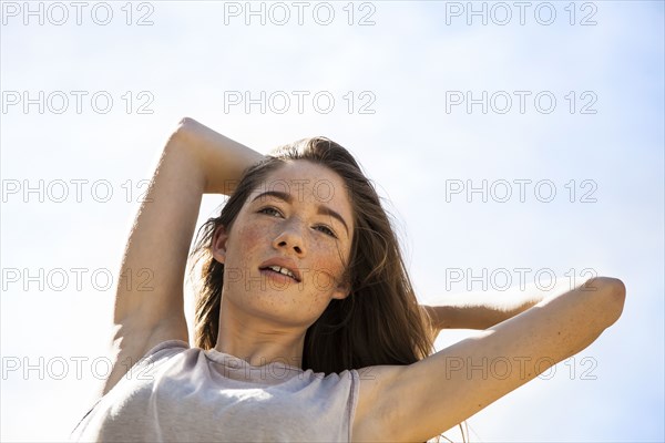 Caucasian woman standing under blue sky