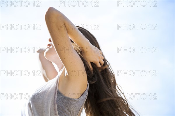 Caucasian woman standing under blue sky