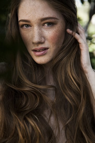 Caucasian woman with long hair and freckles