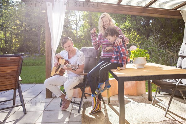 Family relaxing on backyard patio