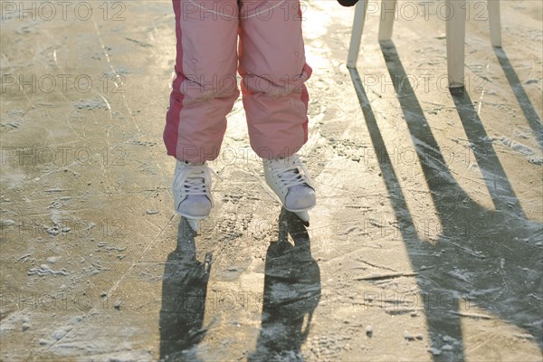 Caucasian girl skating on frozen ice