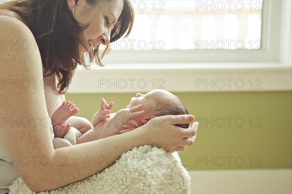 Caucasian mother holding newborn baby