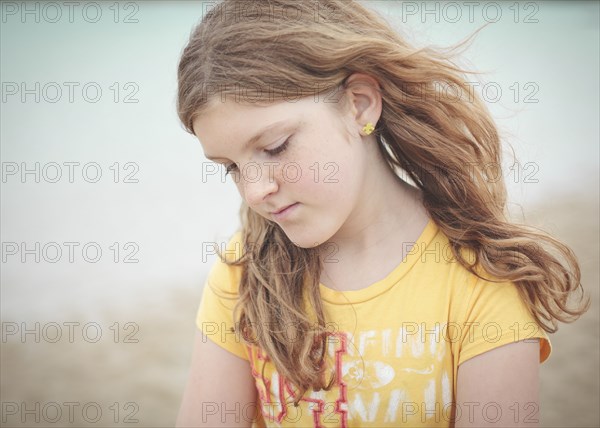 Sad Caucasian girl looking down