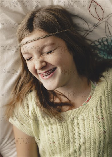 Caucasian girl with braces wearing braid headband