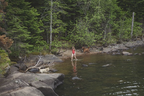 Caucasian girl walking in remote river