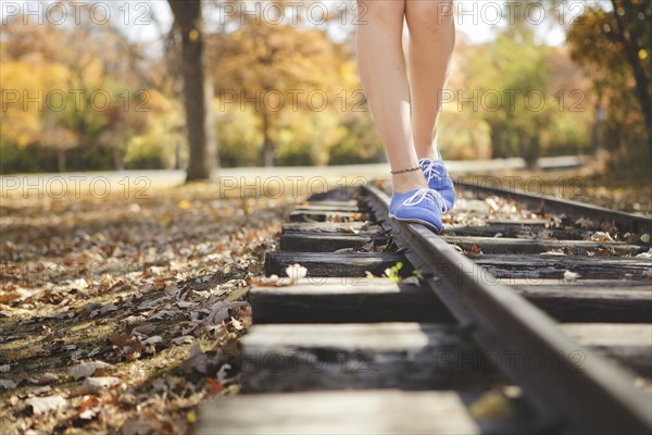 Caucasian girl balancing on train tracks