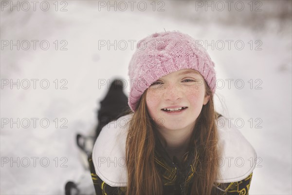 Caucasian girl laying in snow