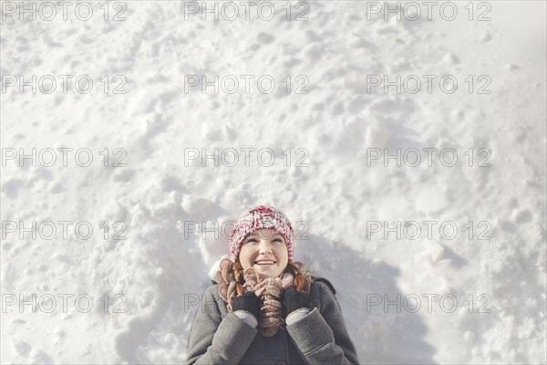 Caucasian girl laying in snow