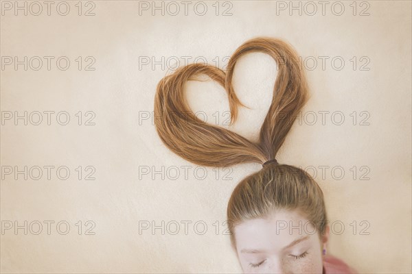 Ponytail of Caucasian girl in heart shape