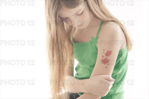 Caucasian girl with temporary tattoo on arm
