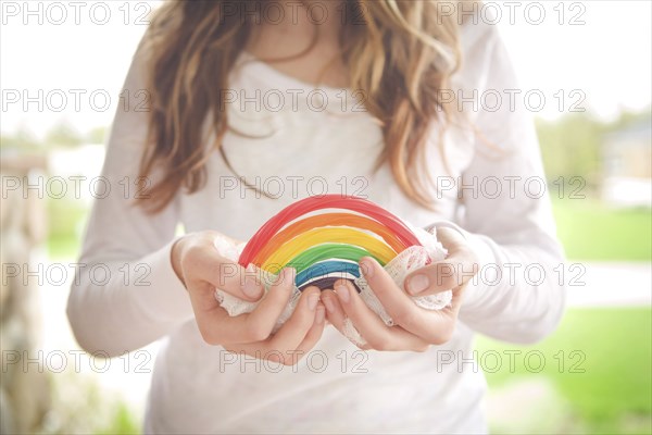 Caucasian girl holding rainbow candy