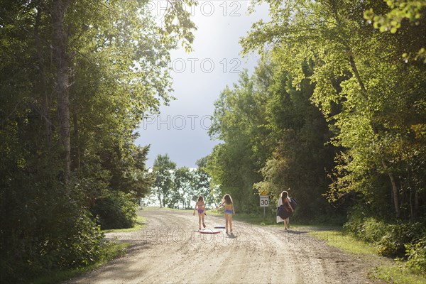 Caucasian girls walking on dirt road