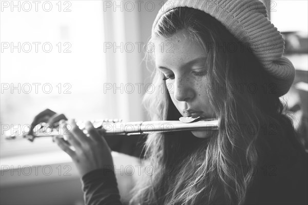 Close up of Caucasian girl playing flute