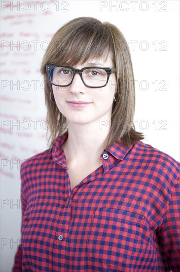 Businesswoman standing at whiteboard in office