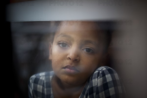 Close up of wistful girl looking out window