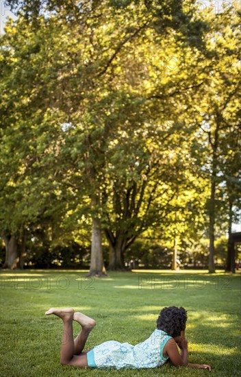 Girl laying in grass in park