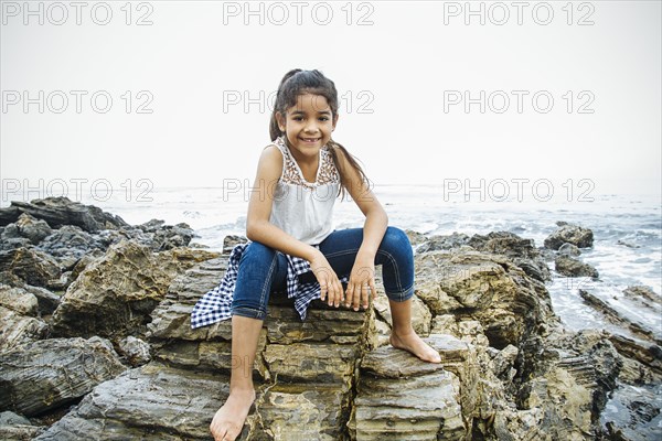 Hispanic girl exploring tide pools