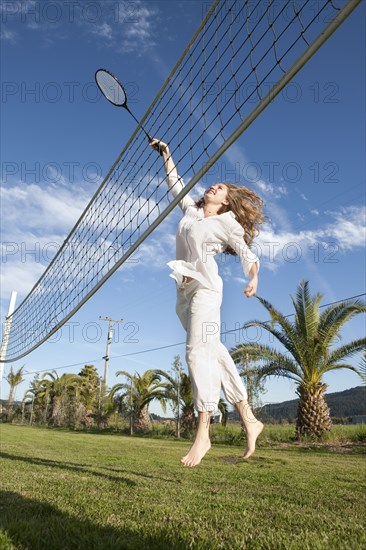 Woman playing badminton in park