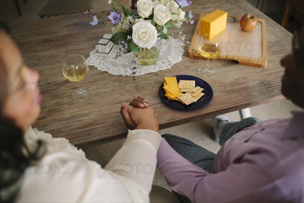 Close up of husband and wife holding hands