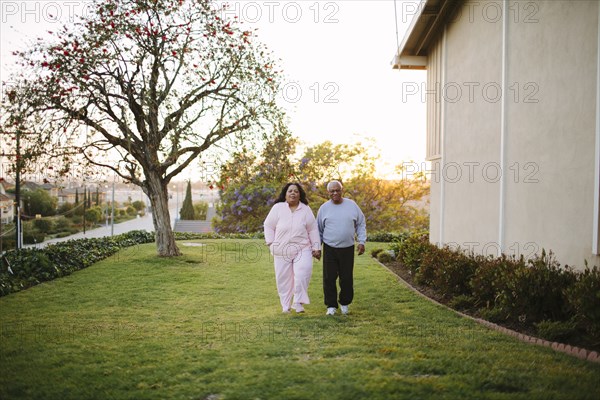 Couple walking in backyard of apartment building