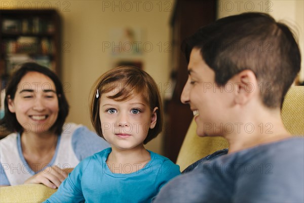 Caucasian family sitting in living room