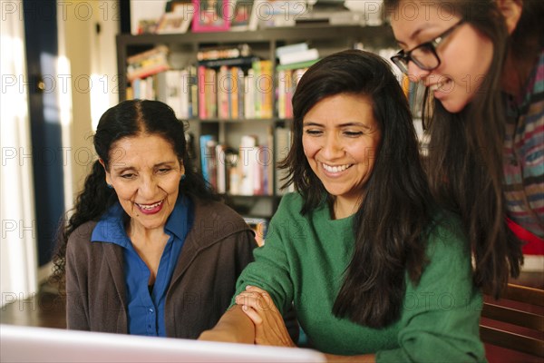 Multi-generation family of women using computer