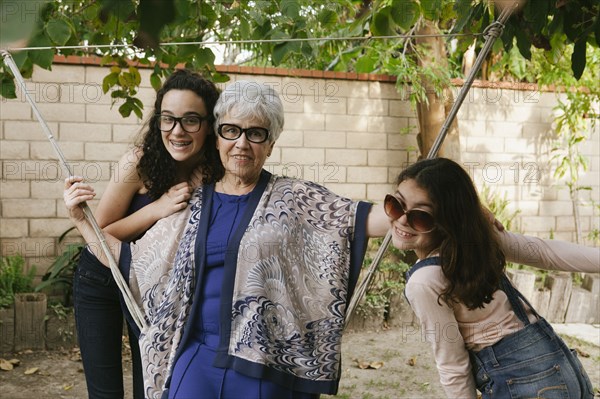 Grandmother and granddaughters playing in backyard