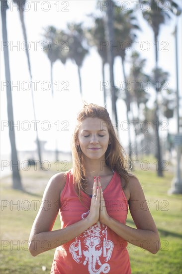 Woman meditating in park