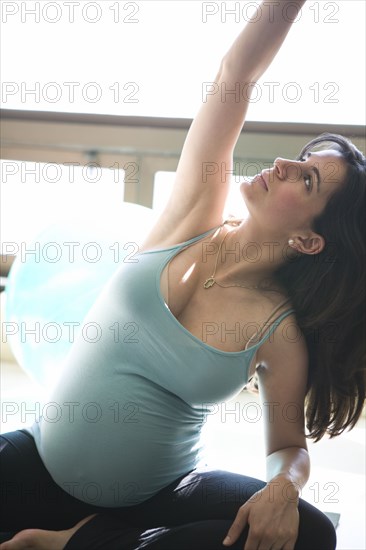 Close up of pregnant woman stretching