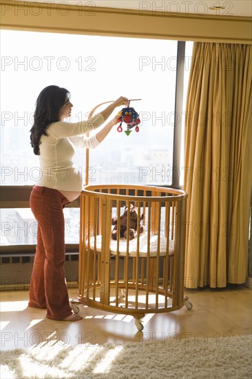 Pregnant woman decorating nursery