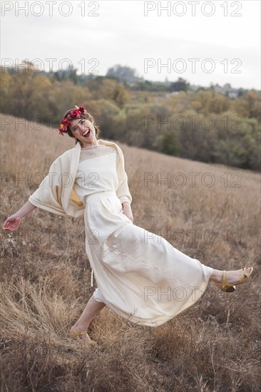 Bride walking on rural hillside