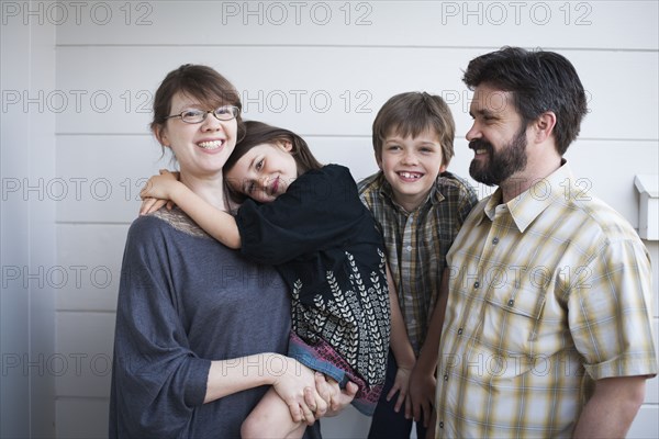 Caucasian parents and children smiling outdoors