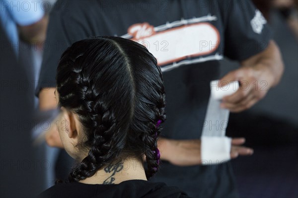 Man wrapping hand near Caucasian girl wearing braids