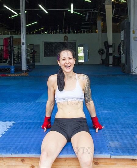 Caucasian boxer laughing in gymnasium