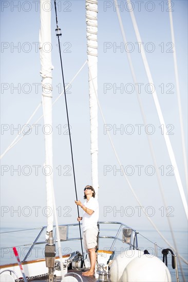 Caucasian woman standing on sailboat deck