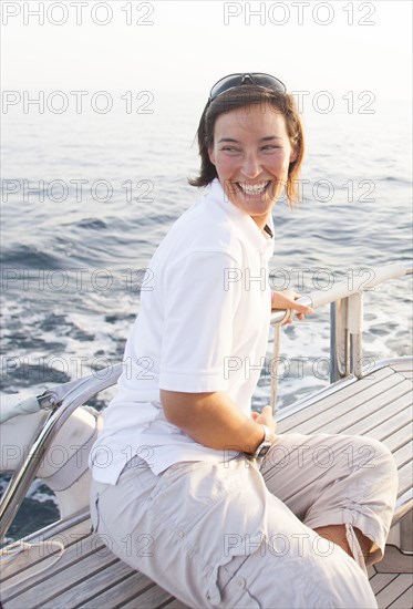 Caucasian woman smiling on boat deck