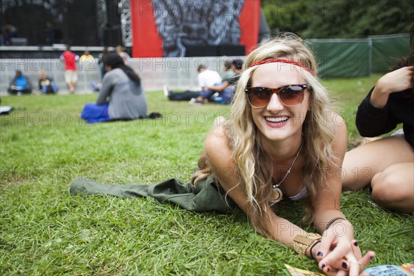 Caucasian woman laying in park grass