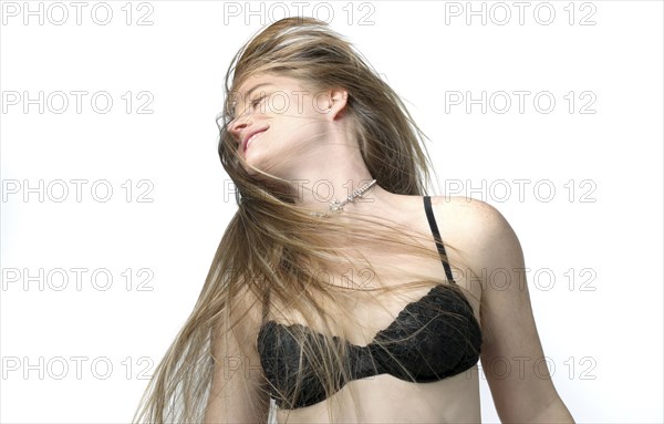 Woman in bra tossing her hair