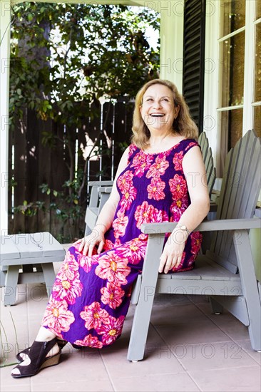 Caucasian woman sitting on porch