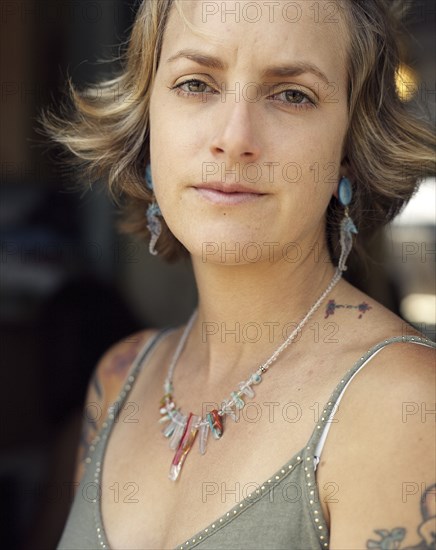 Close up of serious woman wearing jewelry