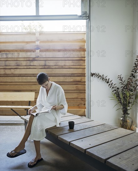 Woman reading magazine in spa