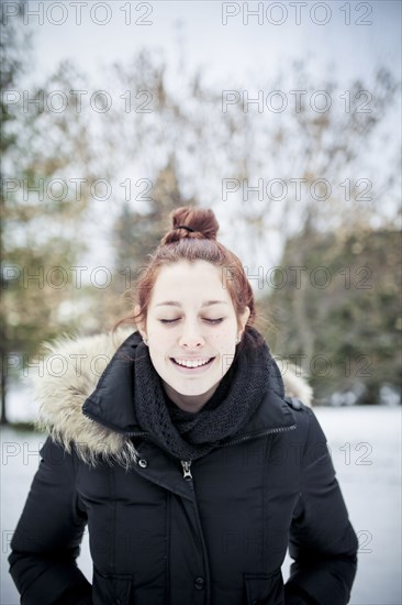 Caucasian teenage girl wearing parka outdoors