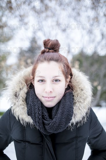 Caucasian teenage girl wearing parka outdoors