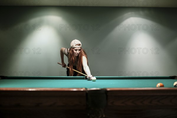 Caucasian teenage girl playing pool
