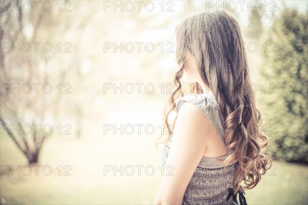 Caucasian teenage girl with curly hair outdoors