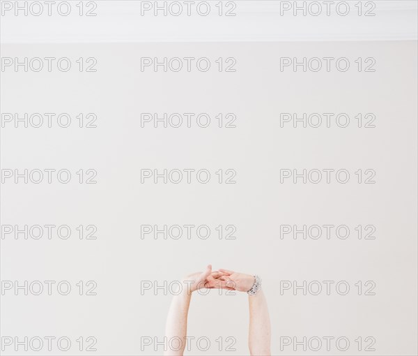 Close up of Caucasian woman stretching arms in midair