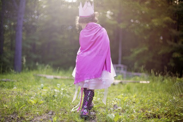 Girl playing princess in backyard