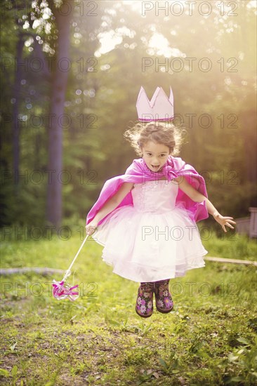 Girl playing princess in backyard