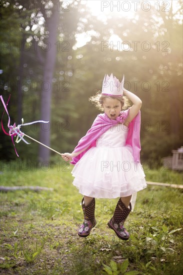 Girl playing princess in backyard